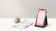 UK pound coins and an invoice beside a smartphone showing social media icons, representing the cost of social media marketing